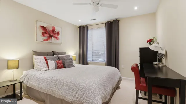 a bedroom with a bed and a desk