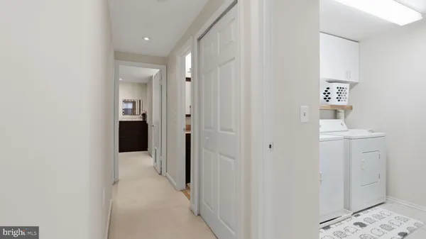 a view of a hallway with some storage and utility room