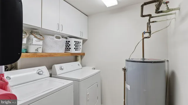 a view of storage and utility room with washer and dryer