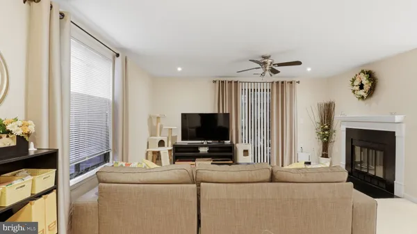a living room with furniture a fireplace and a flat screen tv