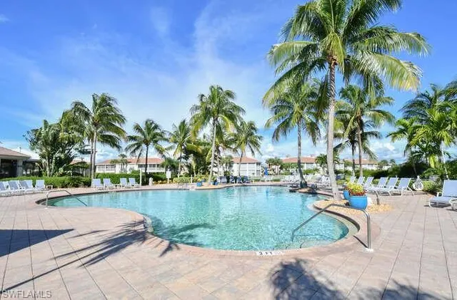 a view of swimming pool with outdoor seating and plants