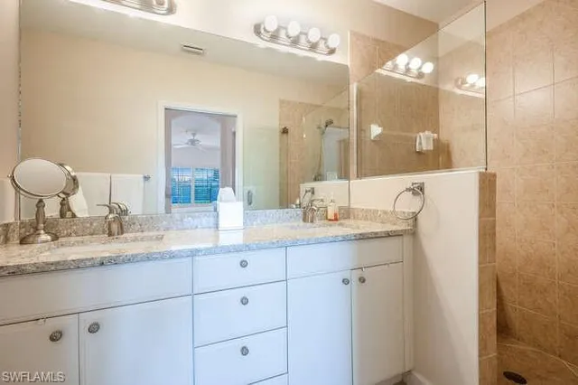 a bathroom with a granite countertop sink mirror and double