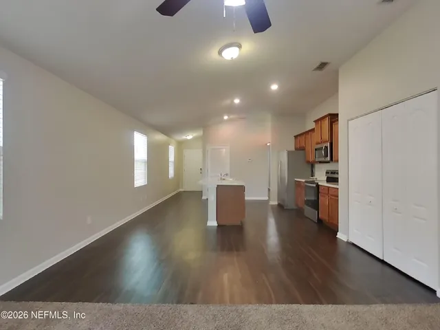 a view of a kitchen with a sink and a window