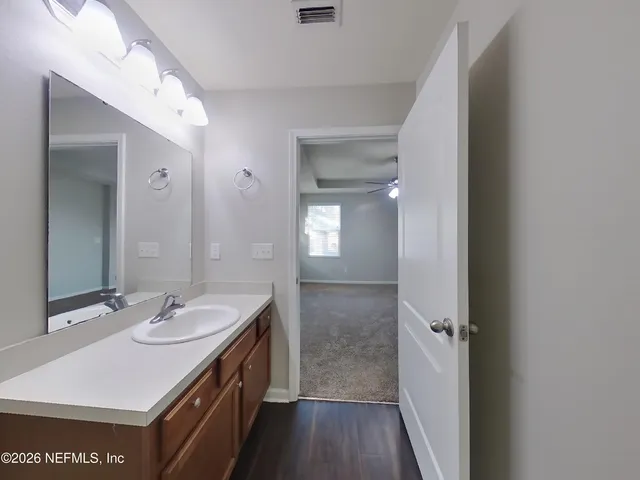 a bathroom with a sink a light fixture a vanity and a mirror