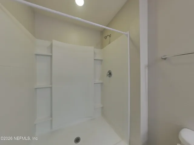 a bathroom with a shower and toilet