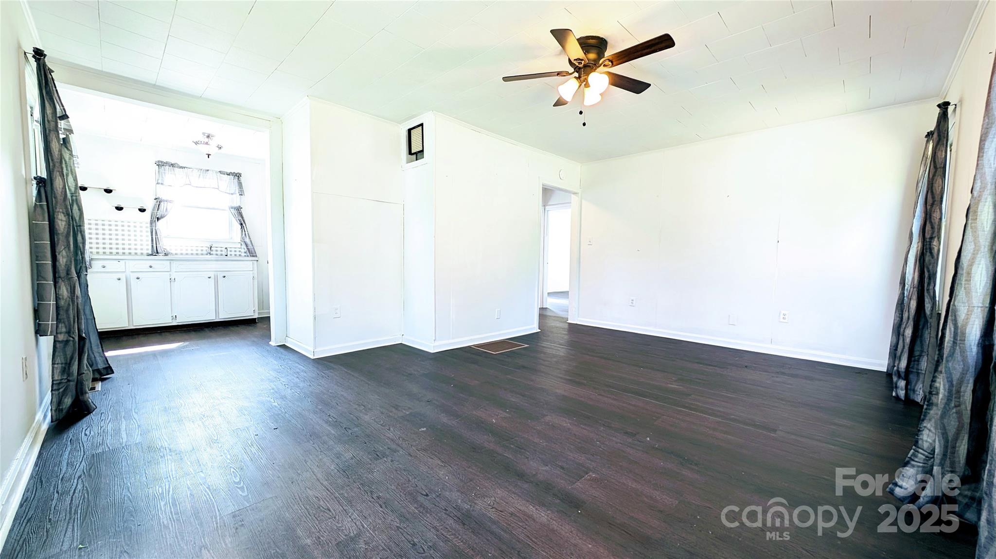 556 6th Street Chester, SC 29706 - Photo 3 of 17 a view of a room with wooden floor and a ceiling fan