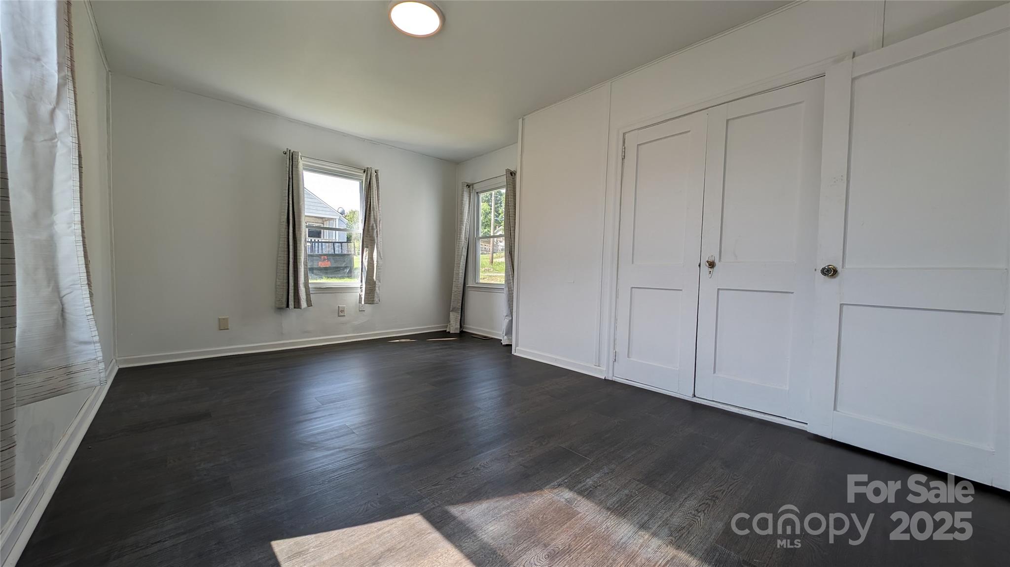 556 6th Street Chester, SC 29706 - Photo 7 of 17 an empty room with wooden floor and windows