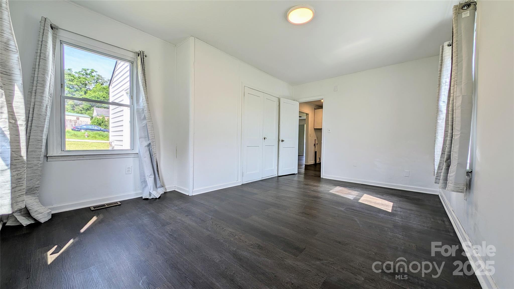 556 6th Street Chester, SC 29706 - Photo 8 of 17 an empty room with wooden floor and windows