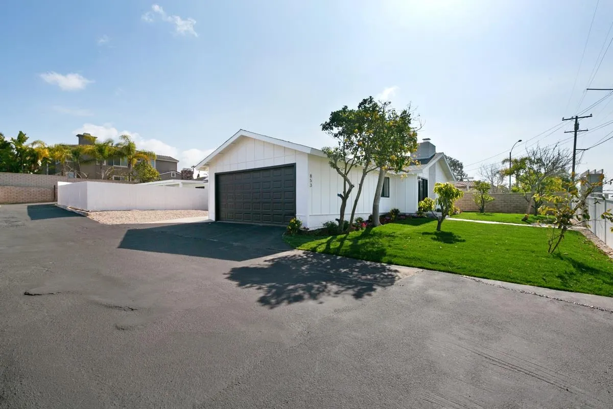 853 Regal Road Encinitas, CA 92024 - Photo 6 of 34 a front view of a house with a yard and a garage