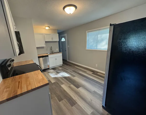 a view of kitchen and wooden floor