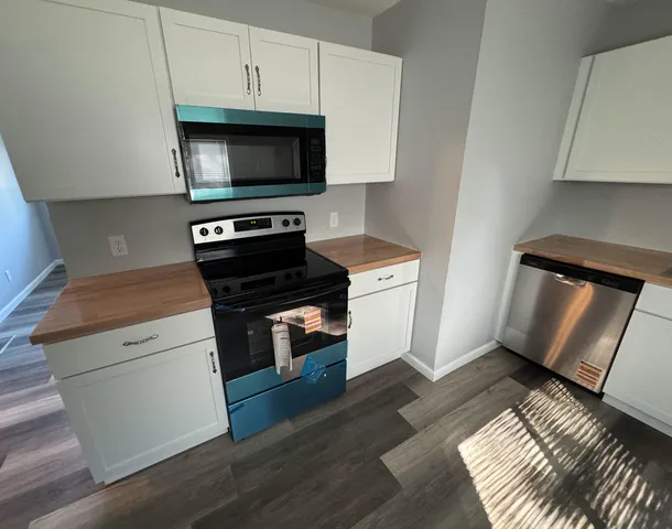 a kitchen with a stove and a microwave