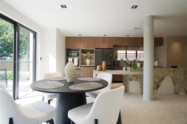 a kitchen with a table and chairs in it