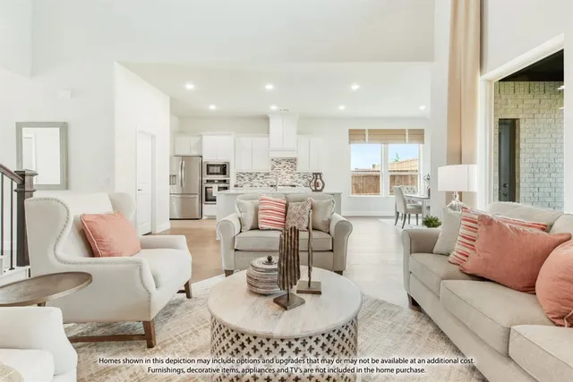 a living room with furniture and a view of kitchen