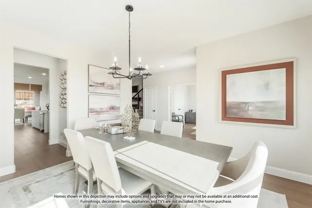 a dining room with a table and chairs