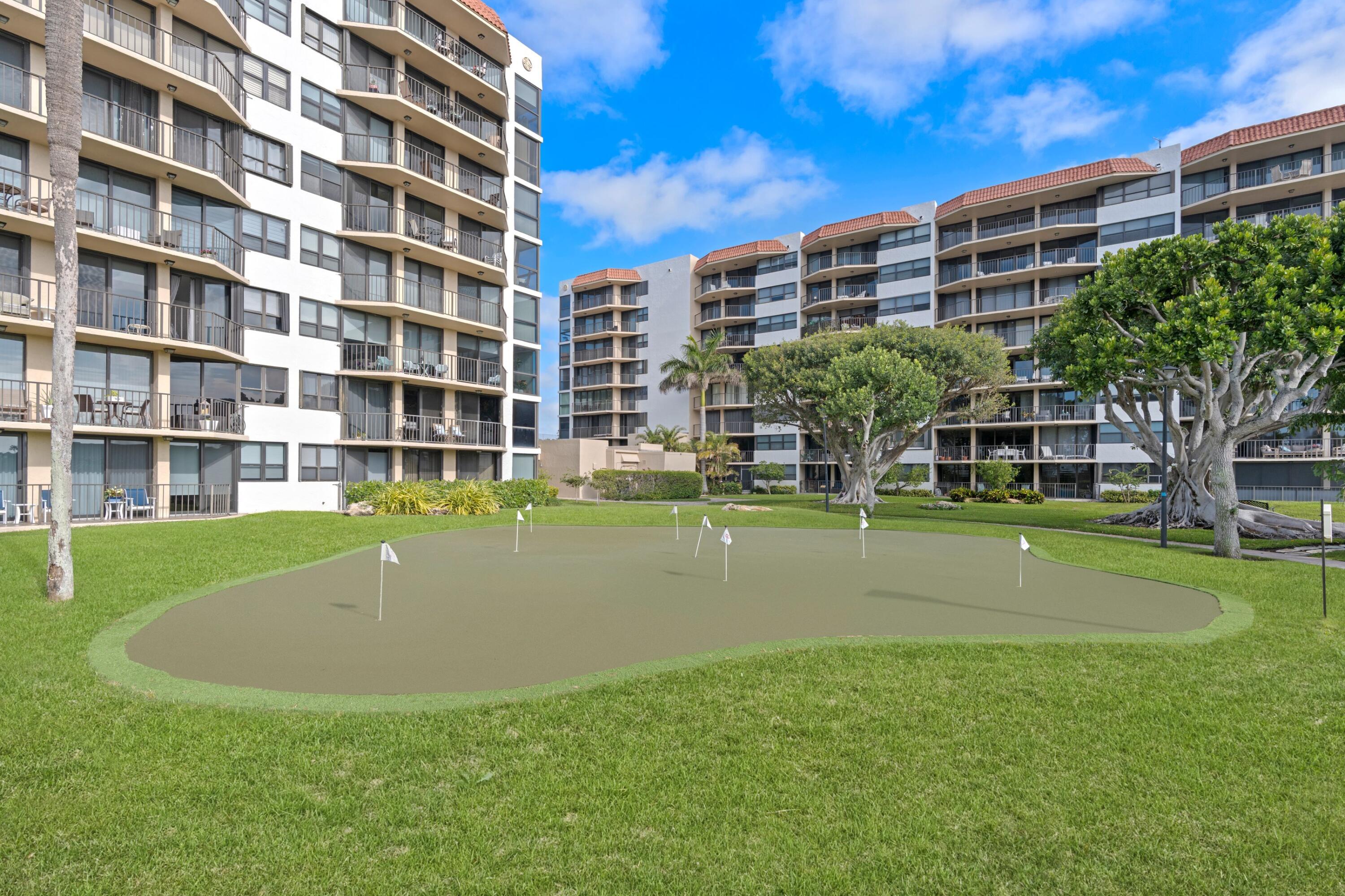 899 Jeffery Street, Unit 112 Boca Raton, FL 33487 - Photo 13 of 33 a view of building with a swimming pool