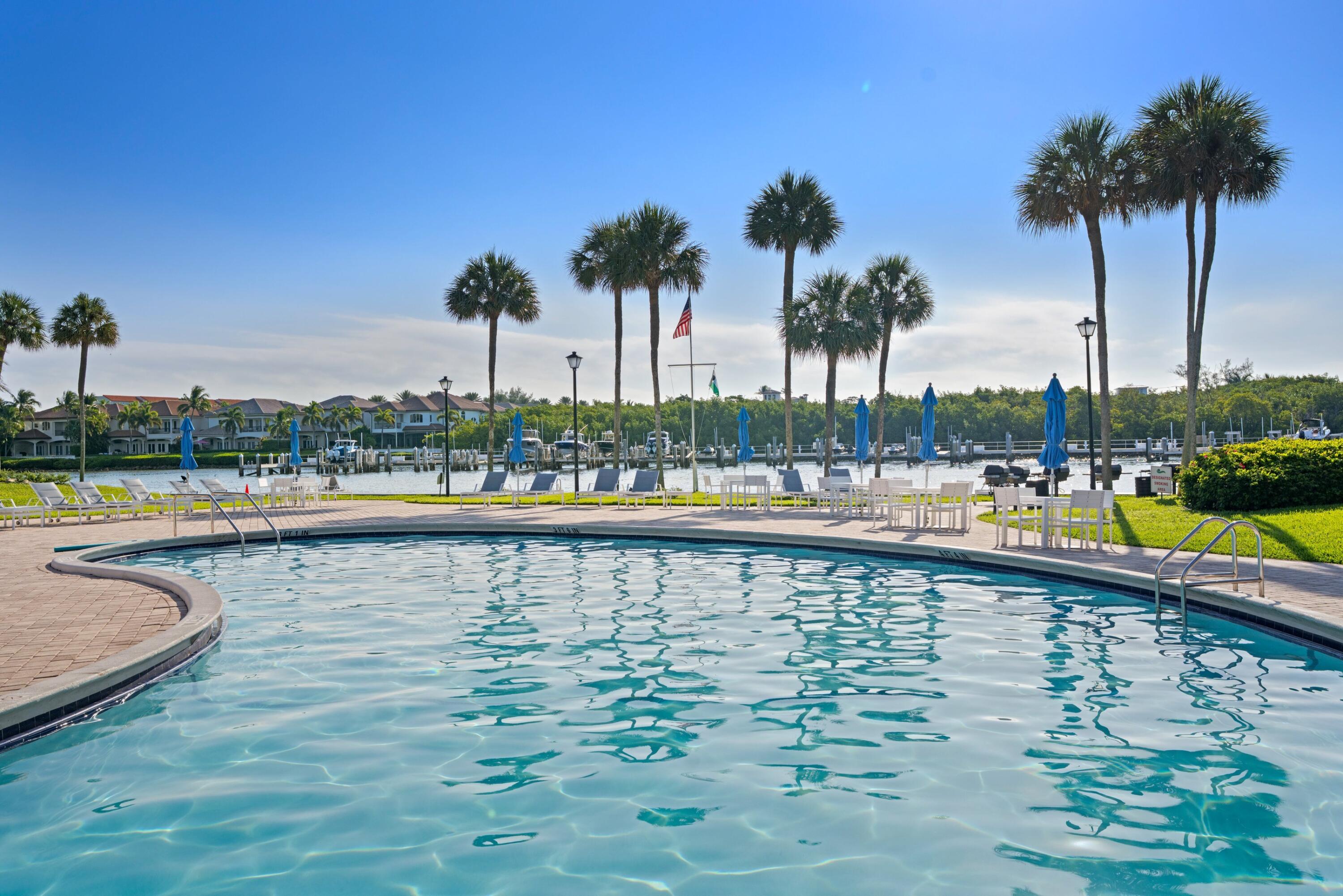 899 Jeffery Street, Unit 112 Boca Raton, FL 33487 - Photo 14 of 33 a view of swimming pool with outdoor seating and lake