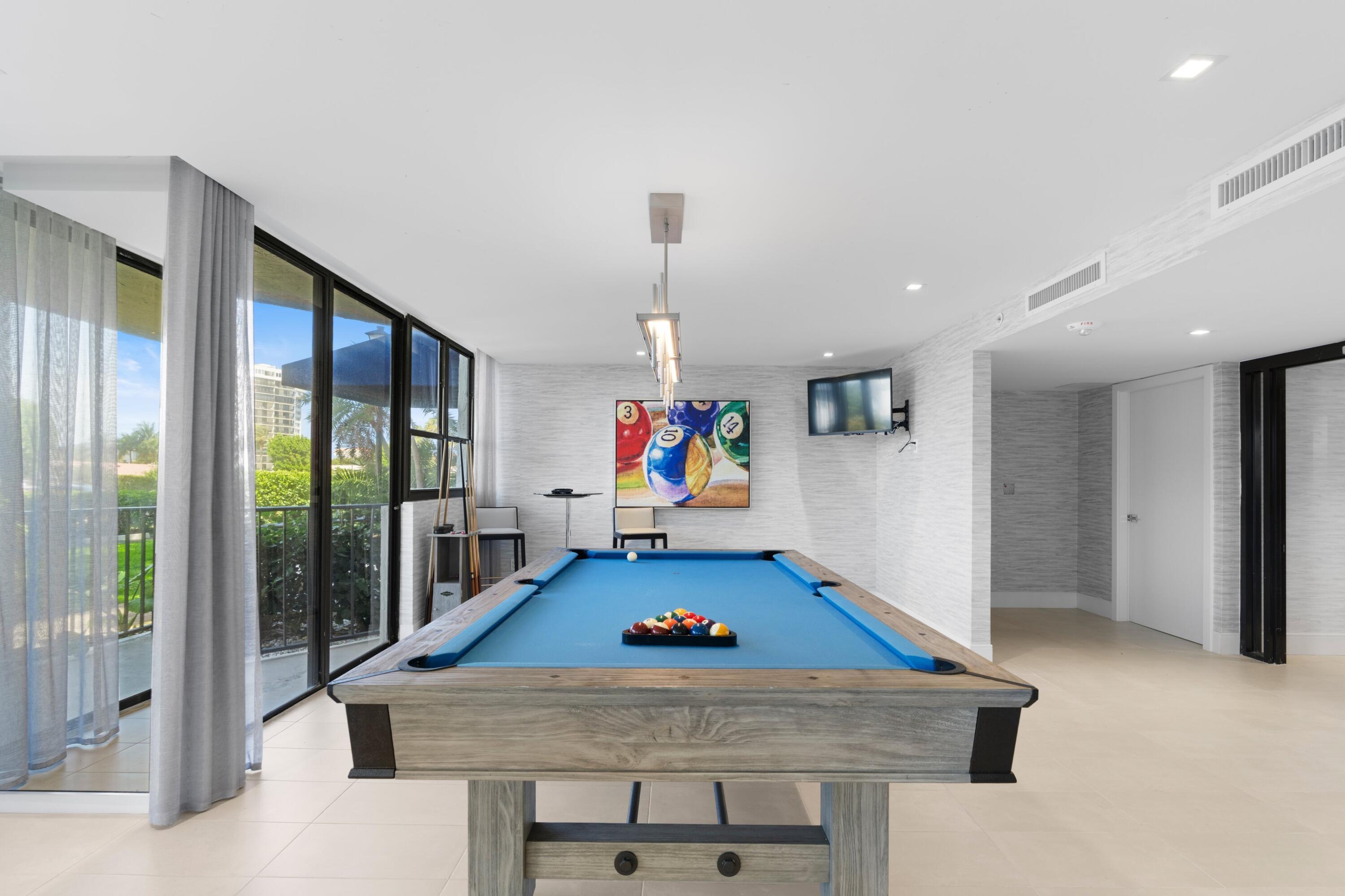 899 Jeffery Street, Unit 112 Boca Raton, FL 33487 - Photo 18 of 33 a living room with furniture pool table and a large window