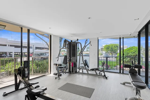 a view of a room with gym equipment and floor to ceiling window