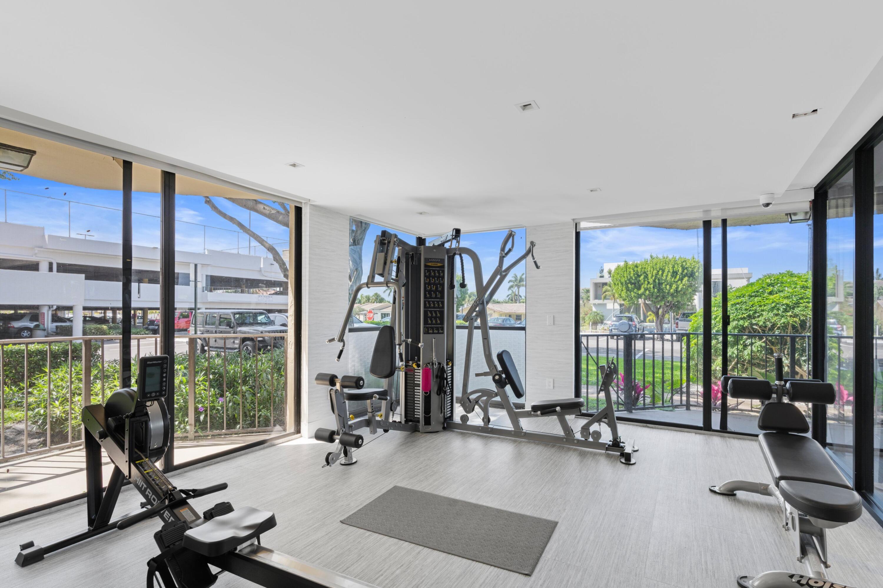 899 Jeffery Street, Unit 112 Boca Raton, FL 33487 - Photo 19 of 33 a view of a room with gym equipment and floor to ceiling window