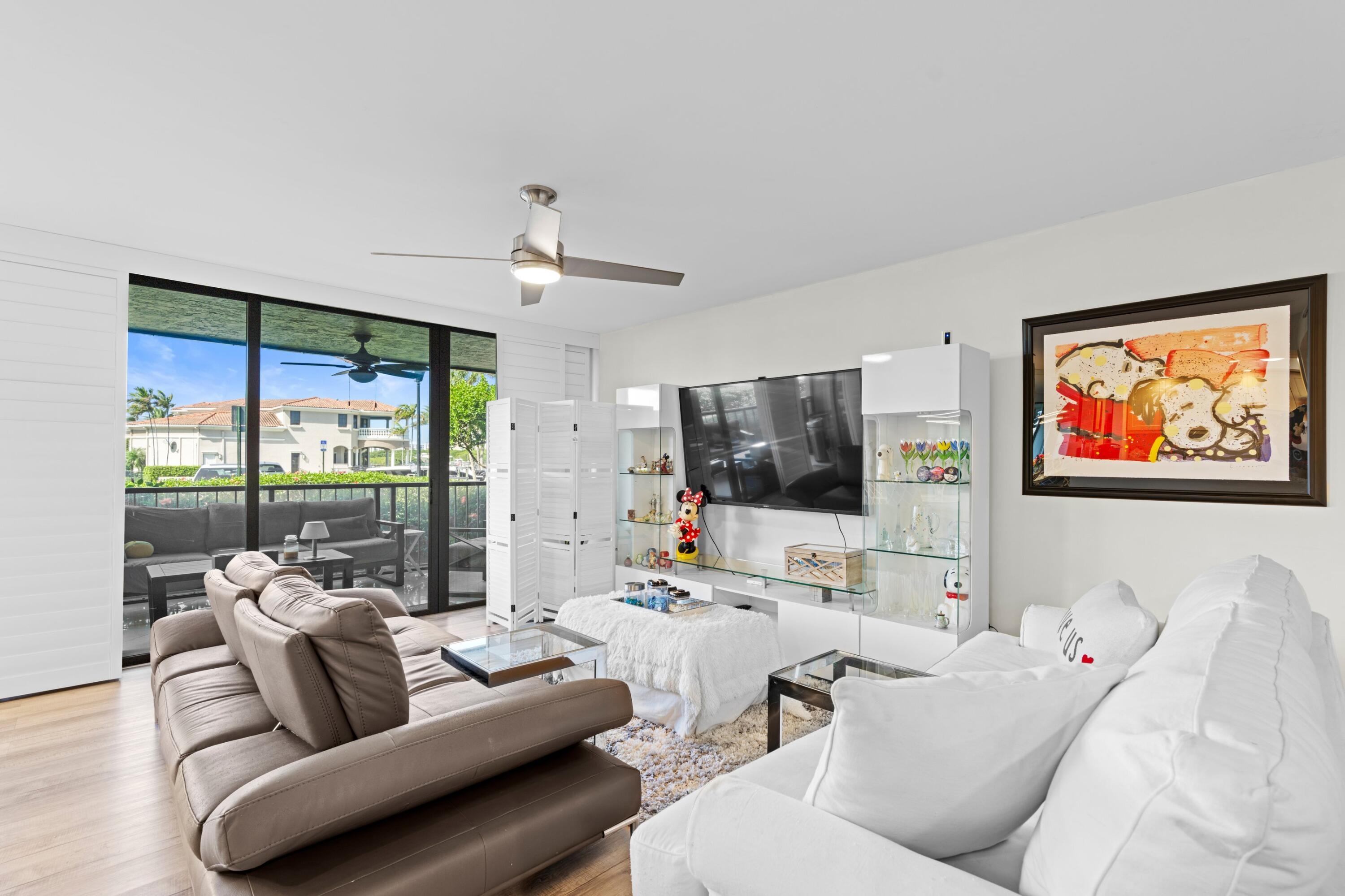 899 Jeffery Street, Unit 112 Boca Raton, FL 33487 - Photo 2 of 33 a living room with furniture and a flat screen tv