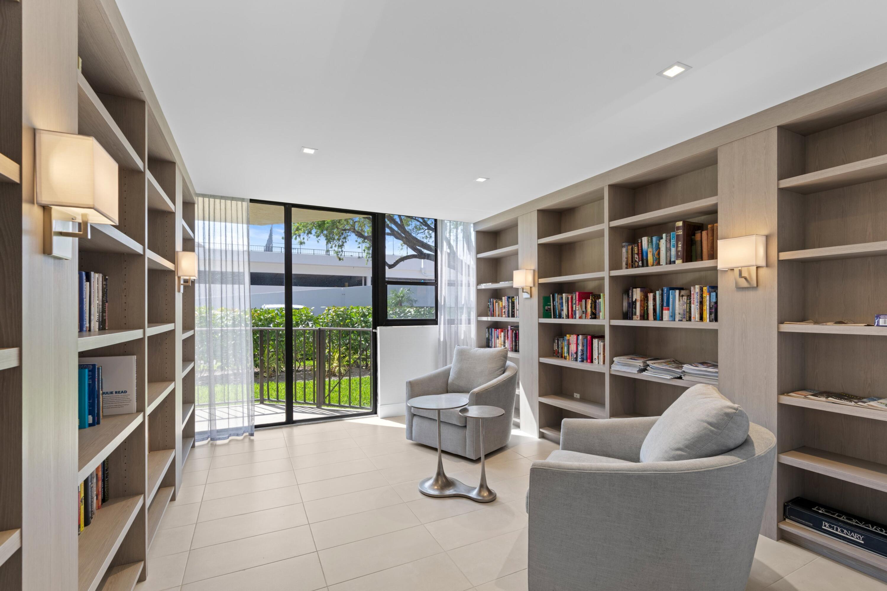899 Jeffery Street, Unit 112 Boca Raton, FL 33487 - Photo 23 of 33 a living room with furniture and a book shelf