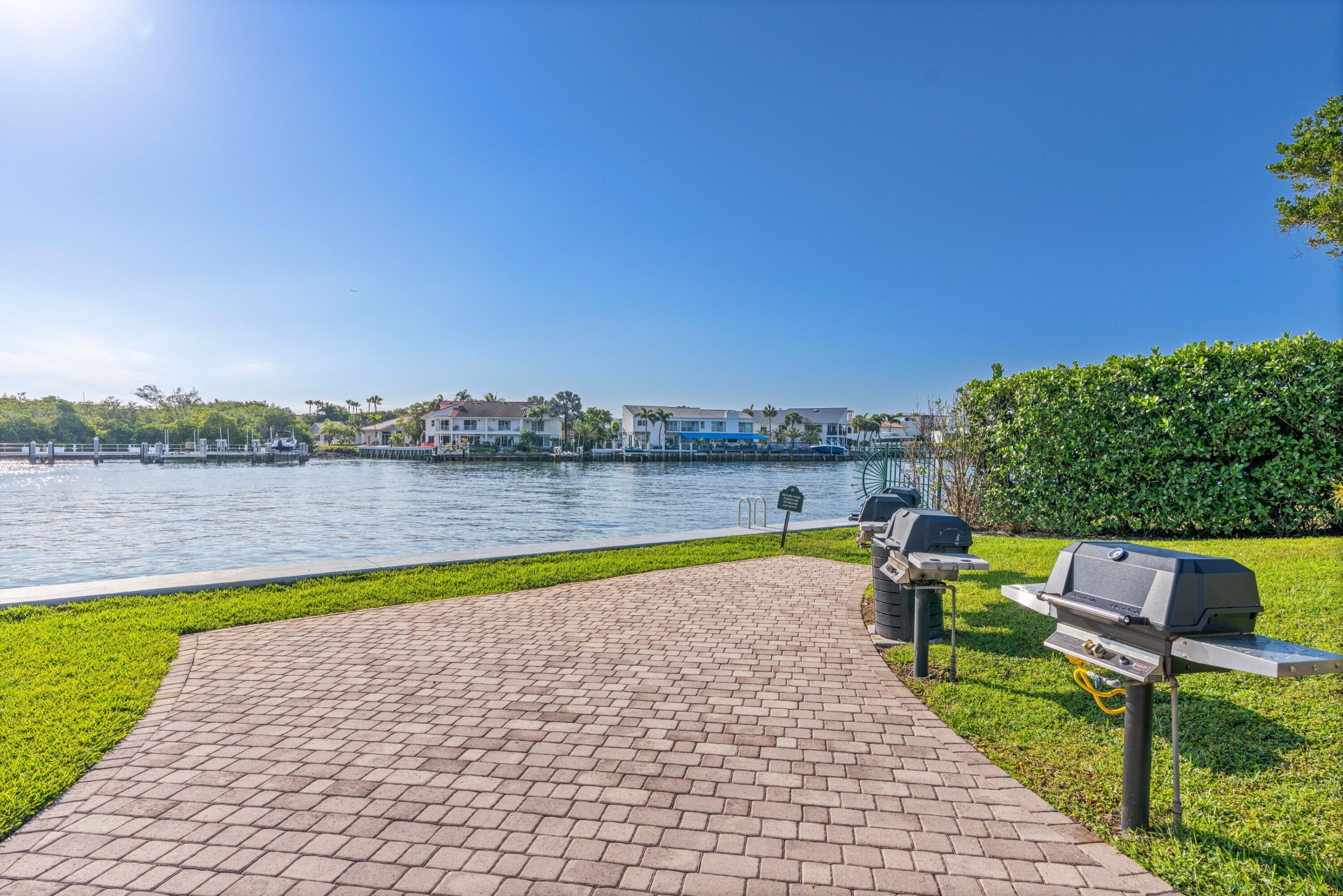 899 Jeffery Street, Unit 112 Boca Raton, FL 33487 - Photo 29 of 33 a view of swimming pool with outdoor seating and yard in the back