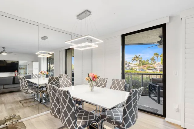 a view of a dining room with furniture and a potted plant