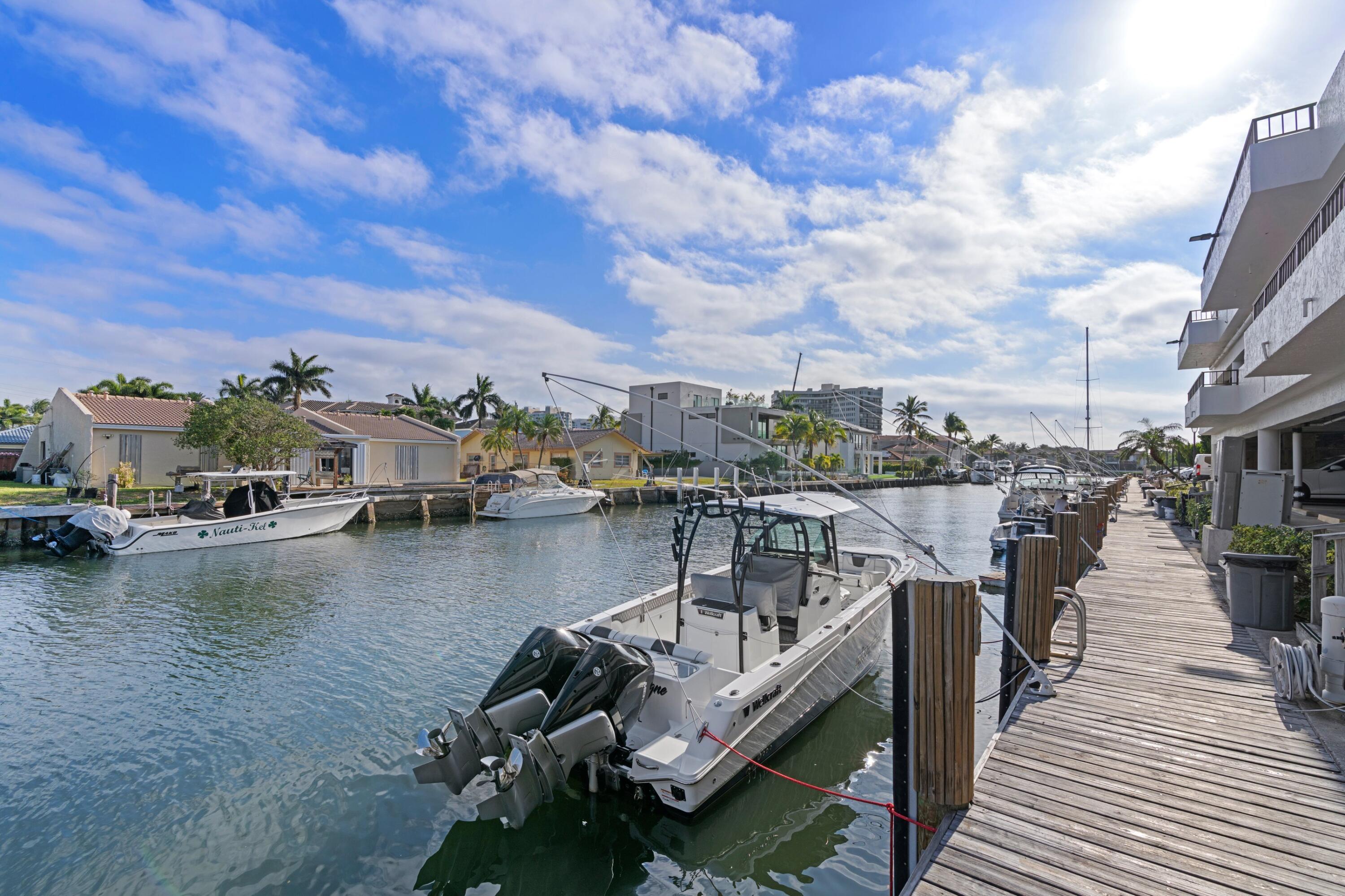 899 Jeffery Street, Unit 112 Boca Raton, FL 33487 - Photo 32 of 33 a view of a ocean with boats and palm trees