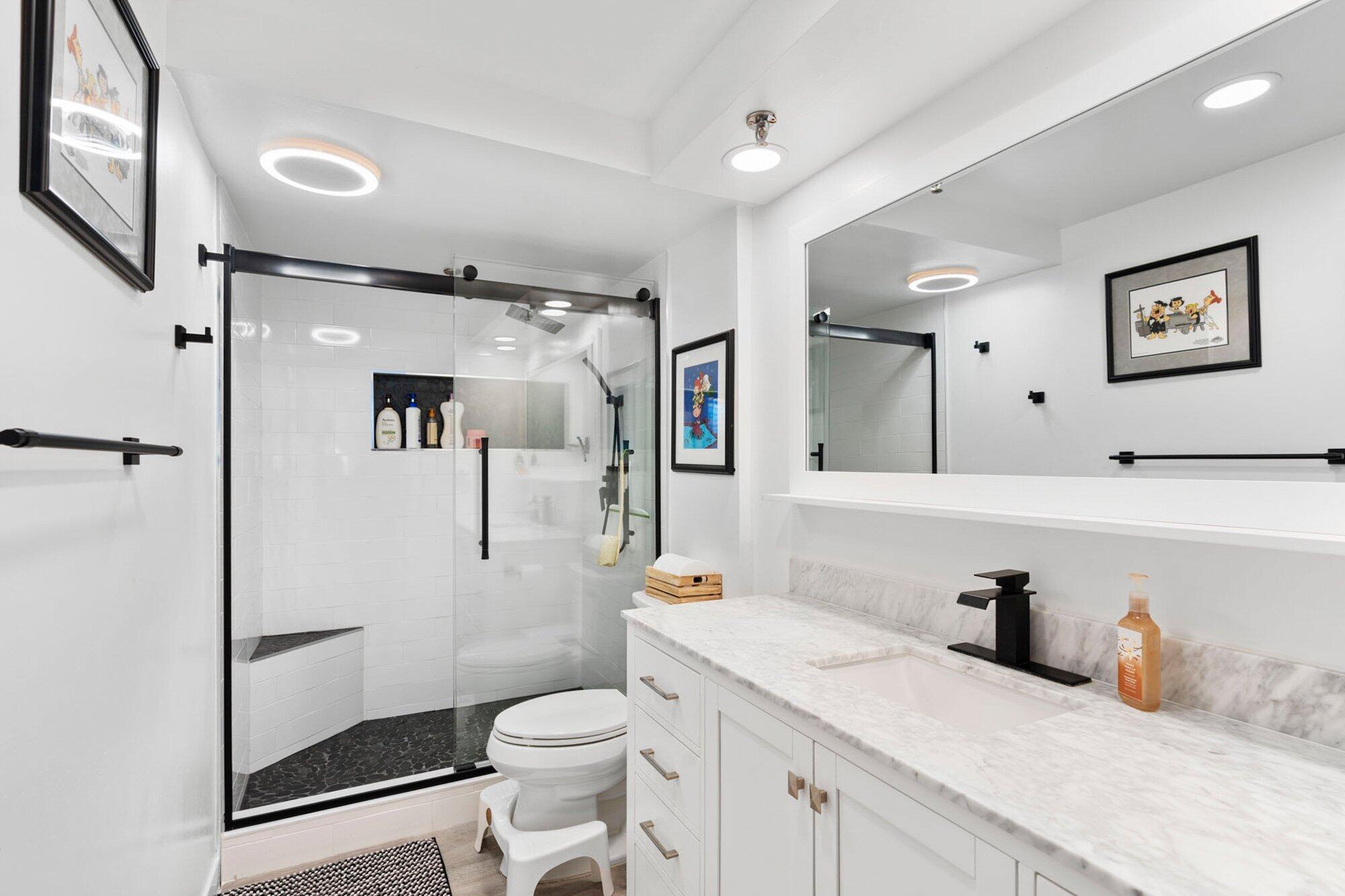 899 Jeffery Street, Unit 112 Boca Raton, FL 33487 - Photo 6 of 33 a bathroom with a granite countertop sink mirror vanity and toilet