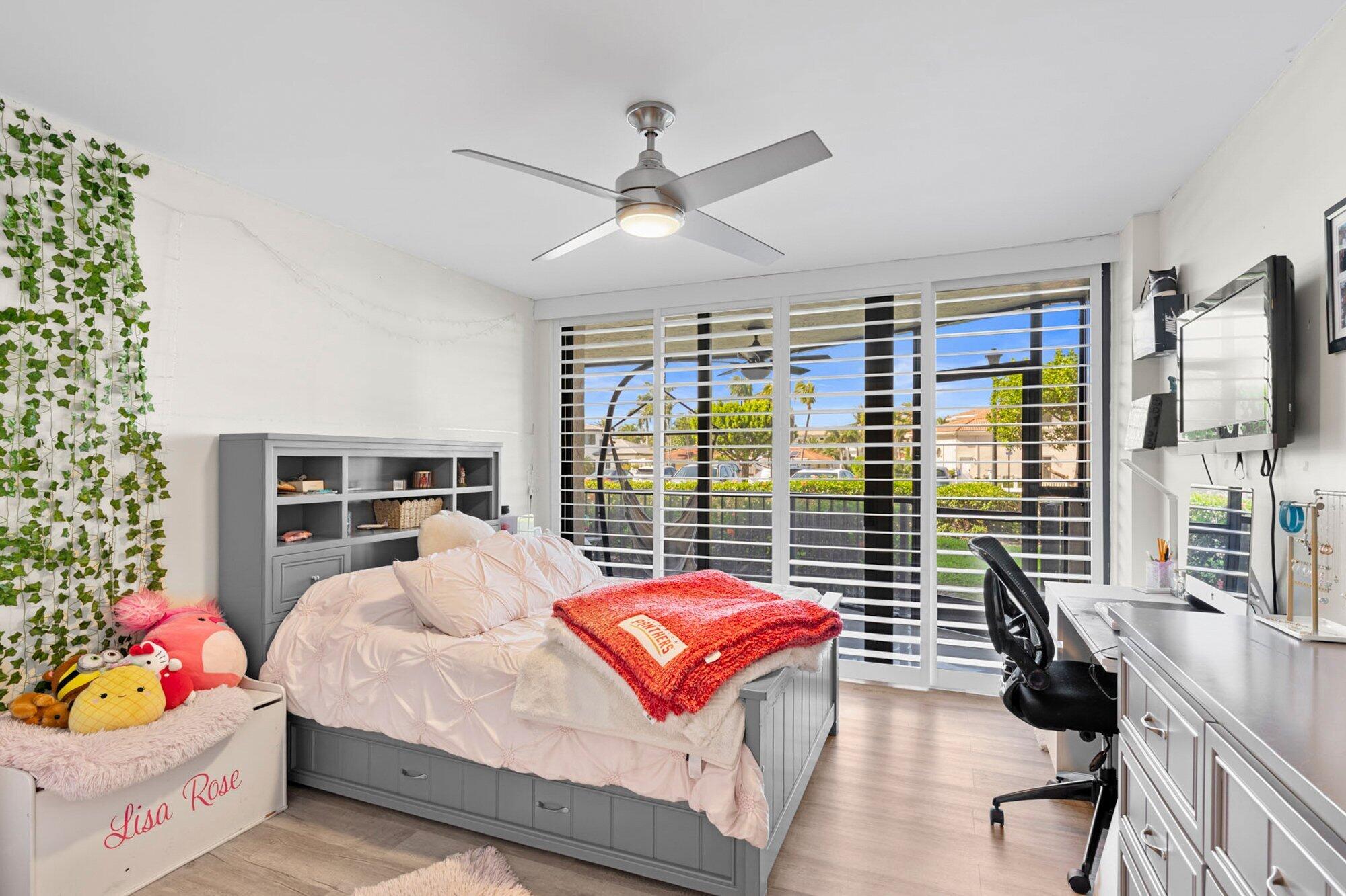 899 Jeffery Street, Unit 112 Boca Raton, FL 33487 - Photo 7 of 33 a bedroom with furniture large window and flat screen tv