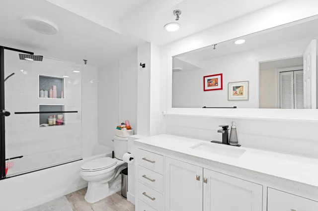a bathroom with a toilet sink and mirror