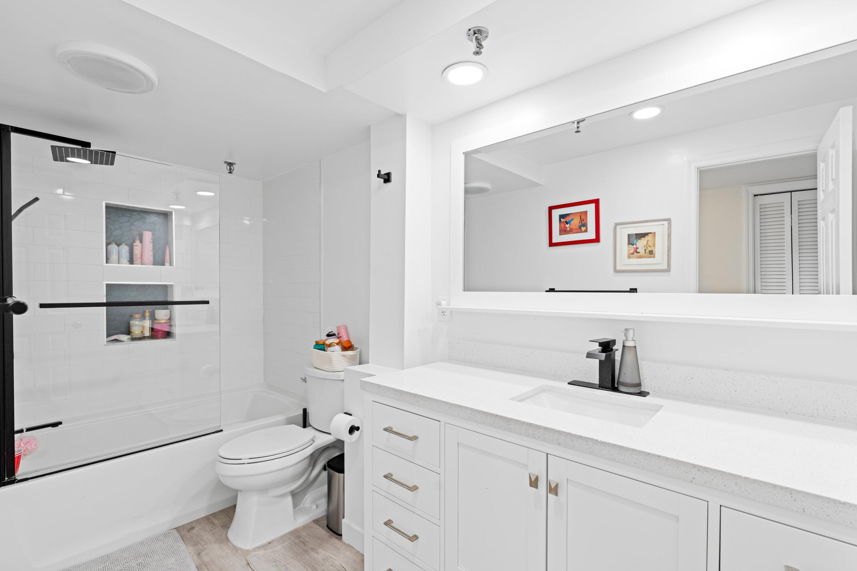 899 Jeffery Street, Unit 112 Boca Raton, FL 33487 - Photo 8 of 33 a bathroom with a toilet sink and mirror