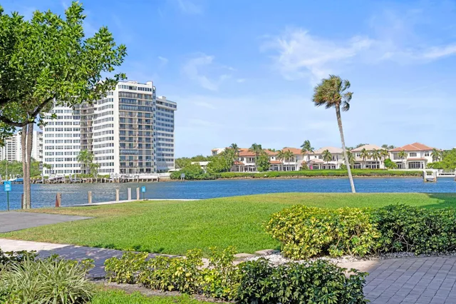 a view of building with garden and statue in the background