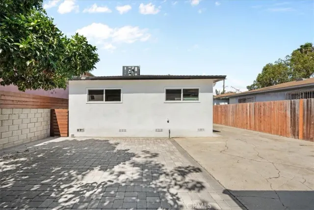 a living room with stainless steel appliances furniture and a kitchen view