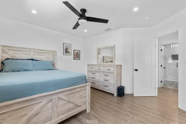 a bedroom with a bed and a view of closet