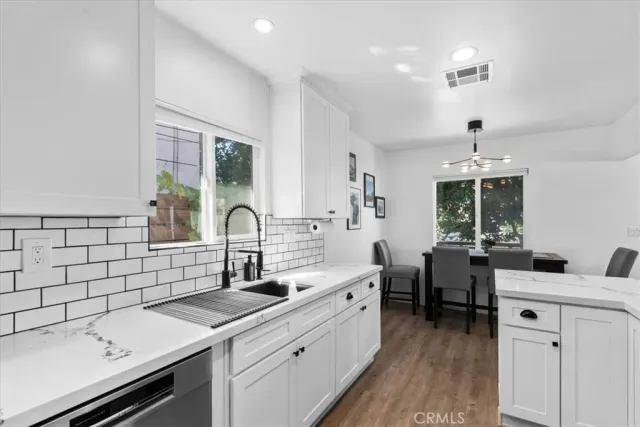 a kitchen with a sink and a stove top oven
