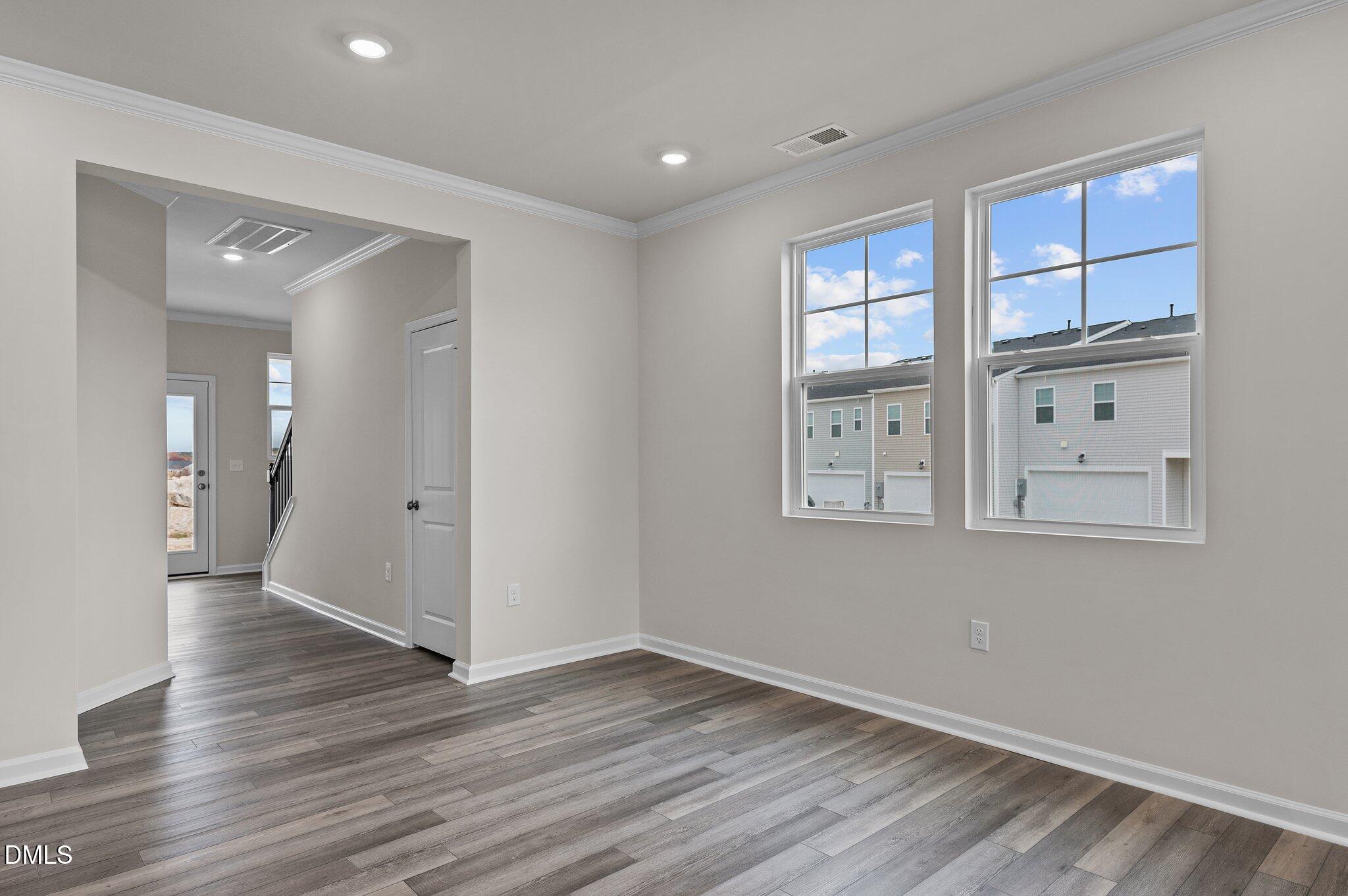2202 Kasota Lane Raleigh, NC 27610 - Photo 22 of 79 a view of an empty room with wooden floor and a window