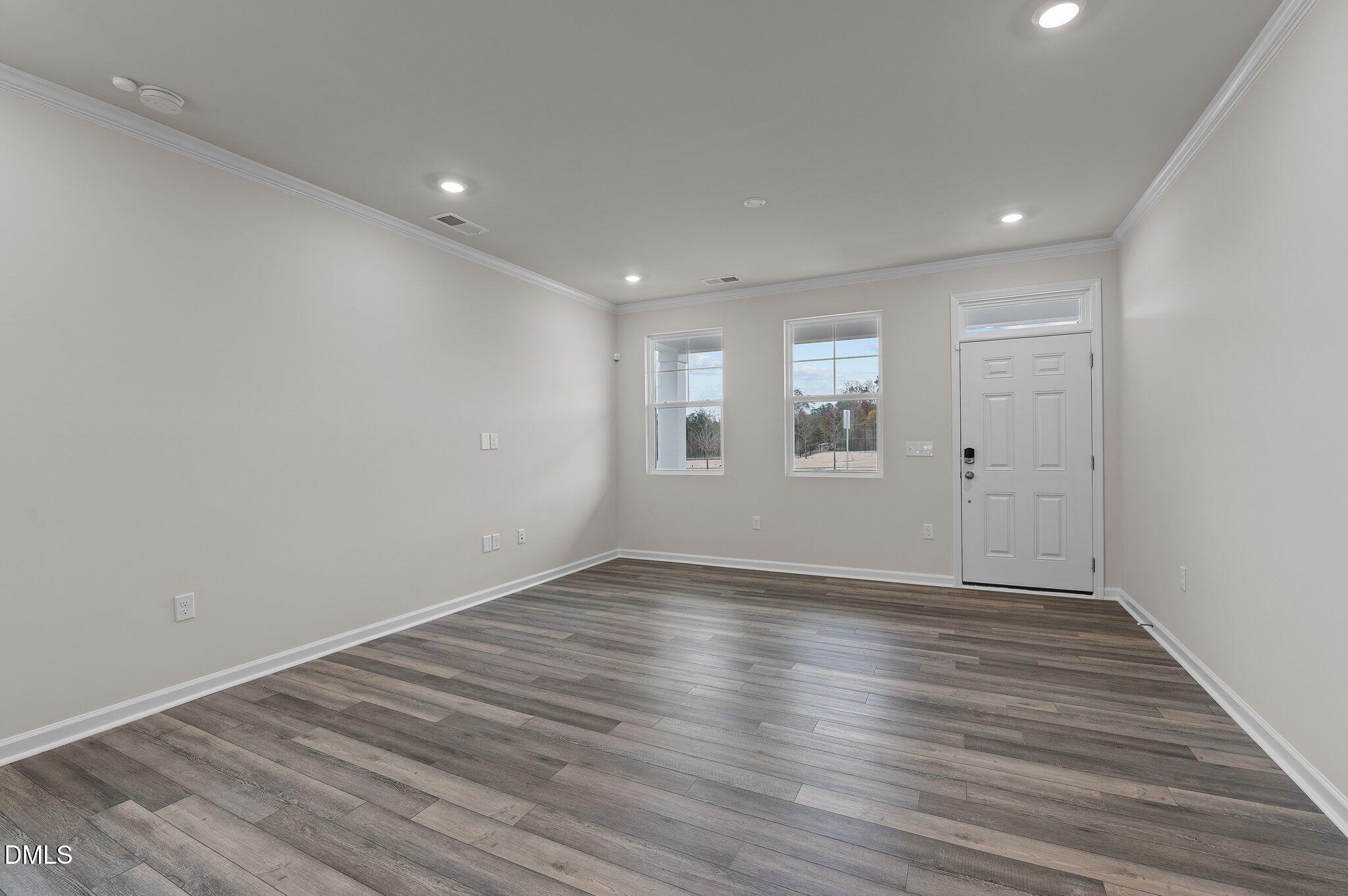 2202 Kasota Lane Raleigh, NC 27610 - Photo 24 of 79 a view of an empty room with wooden floor and windows