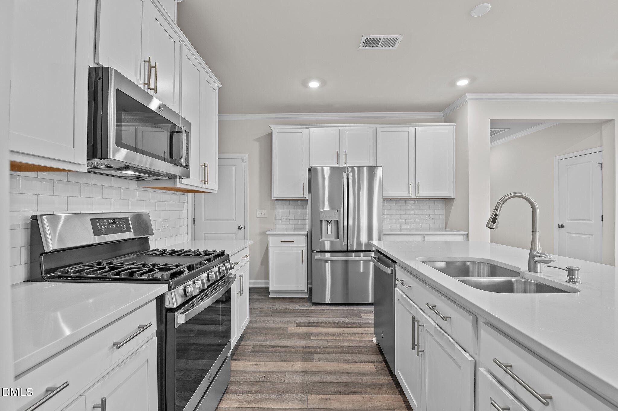 2202 Kasota Lane Raleigh, NC 27610 - Photo 27 of 79 a kitchen with stainless steel appliances granite countertop a sink stove and refrigerator