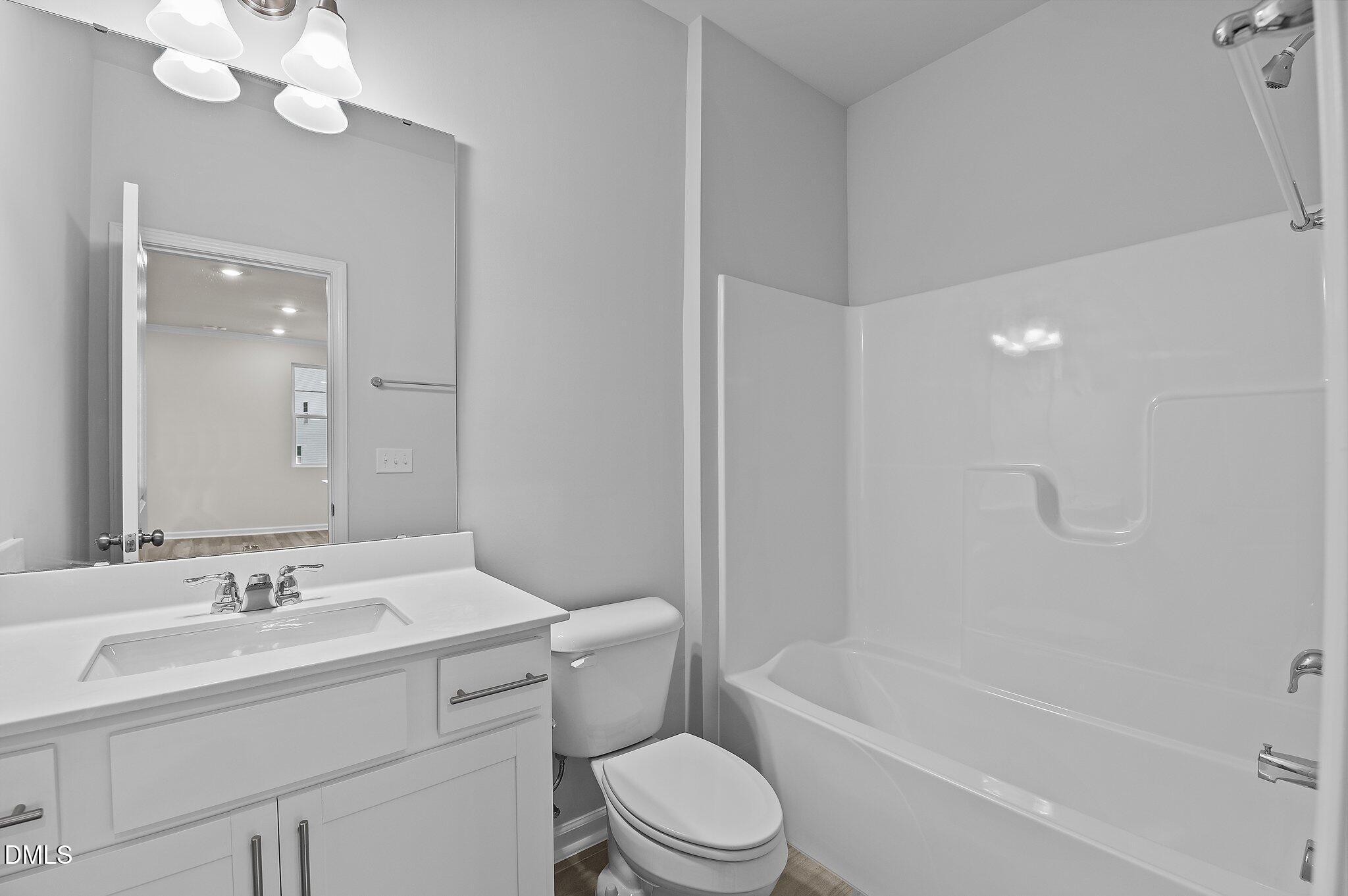 2202 Kasota Lane Raleigh, NC 27610 - Photo 28 of 79 a bathroom with a sink a toilet and shower