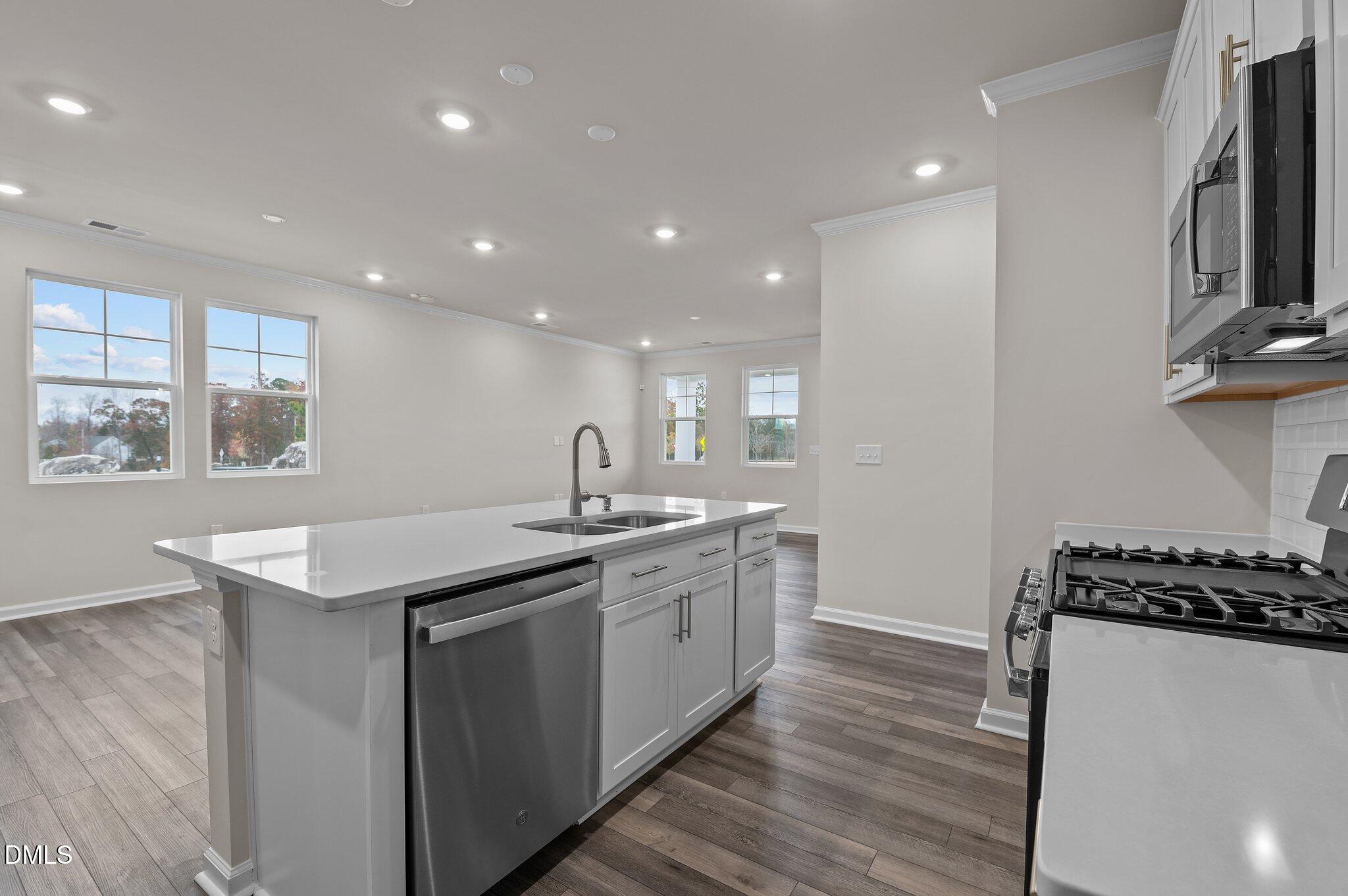 2202 Kasota Lane Raleigh, NC 27610 - Photo 31 of 79 a kitchen with stainless steel appliances granite countertop a sink stove and cabinets