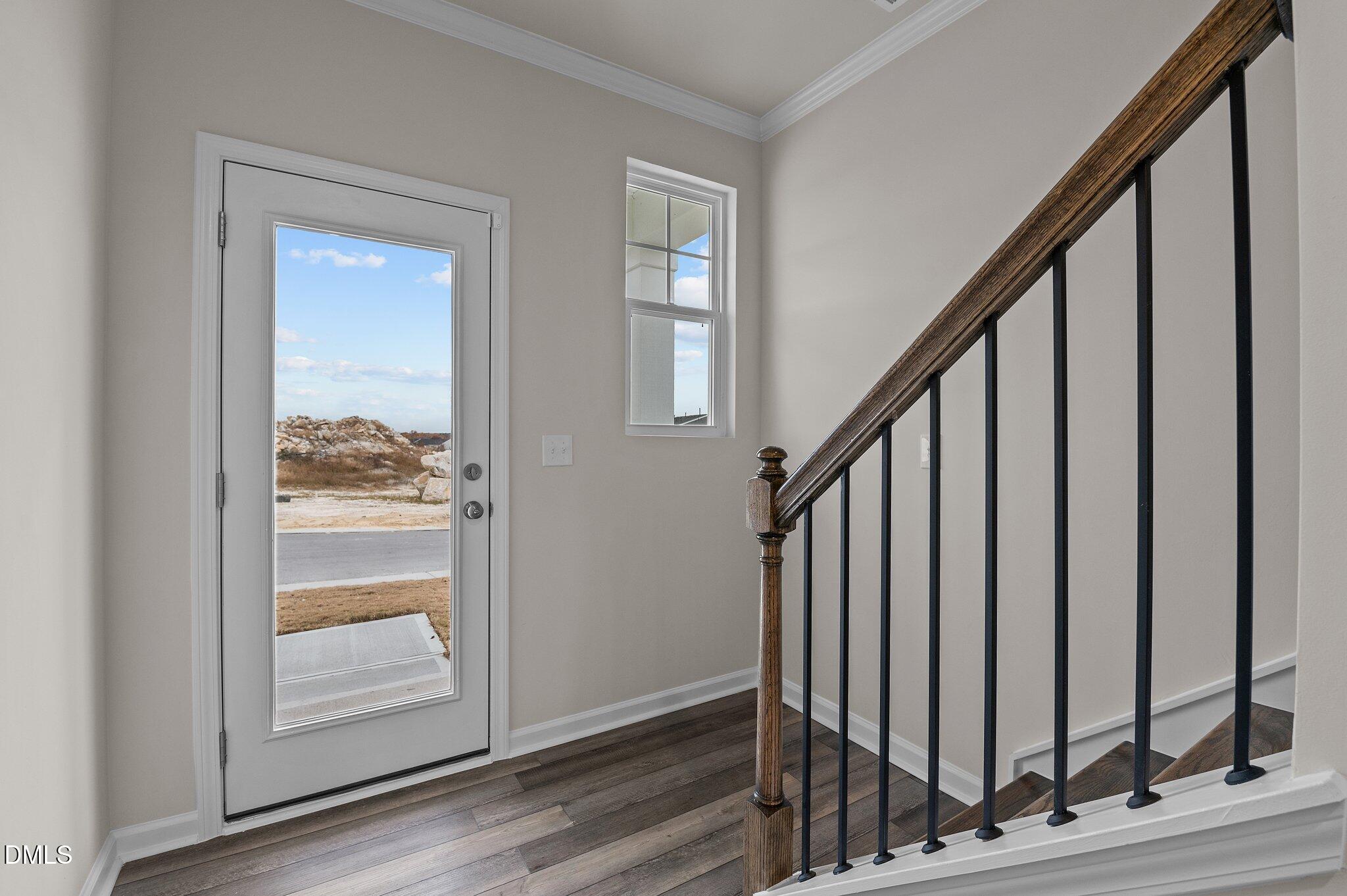 2202 Kasota Lane Raleigh, NC 27610 - Photo 32 of 79 a view of an entryway with wooden floor and stairs