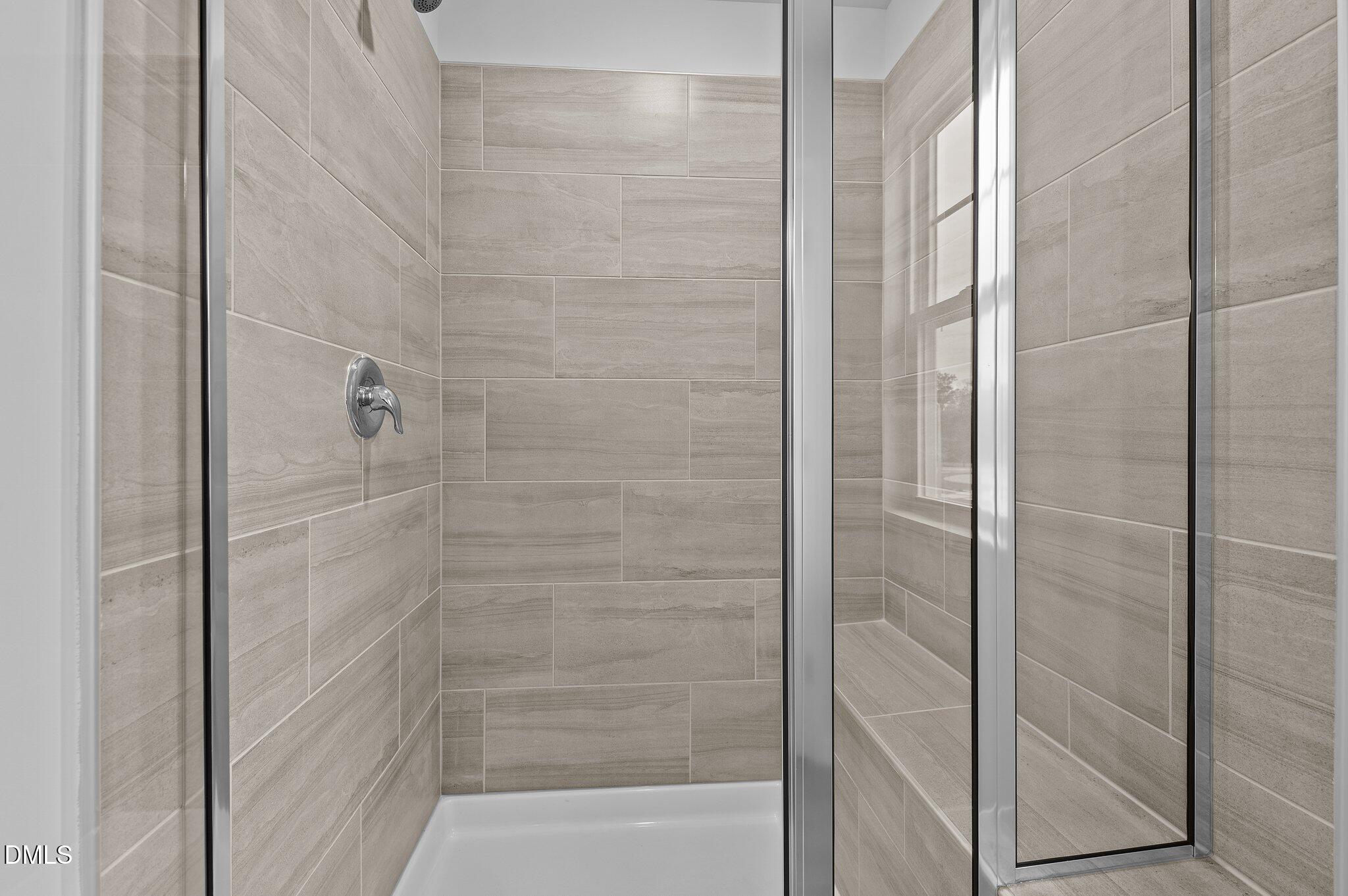 2202 Kasota Lane Raleigh, NC 27610 - Photo 40 of 79 a bathroom with a glass shower door