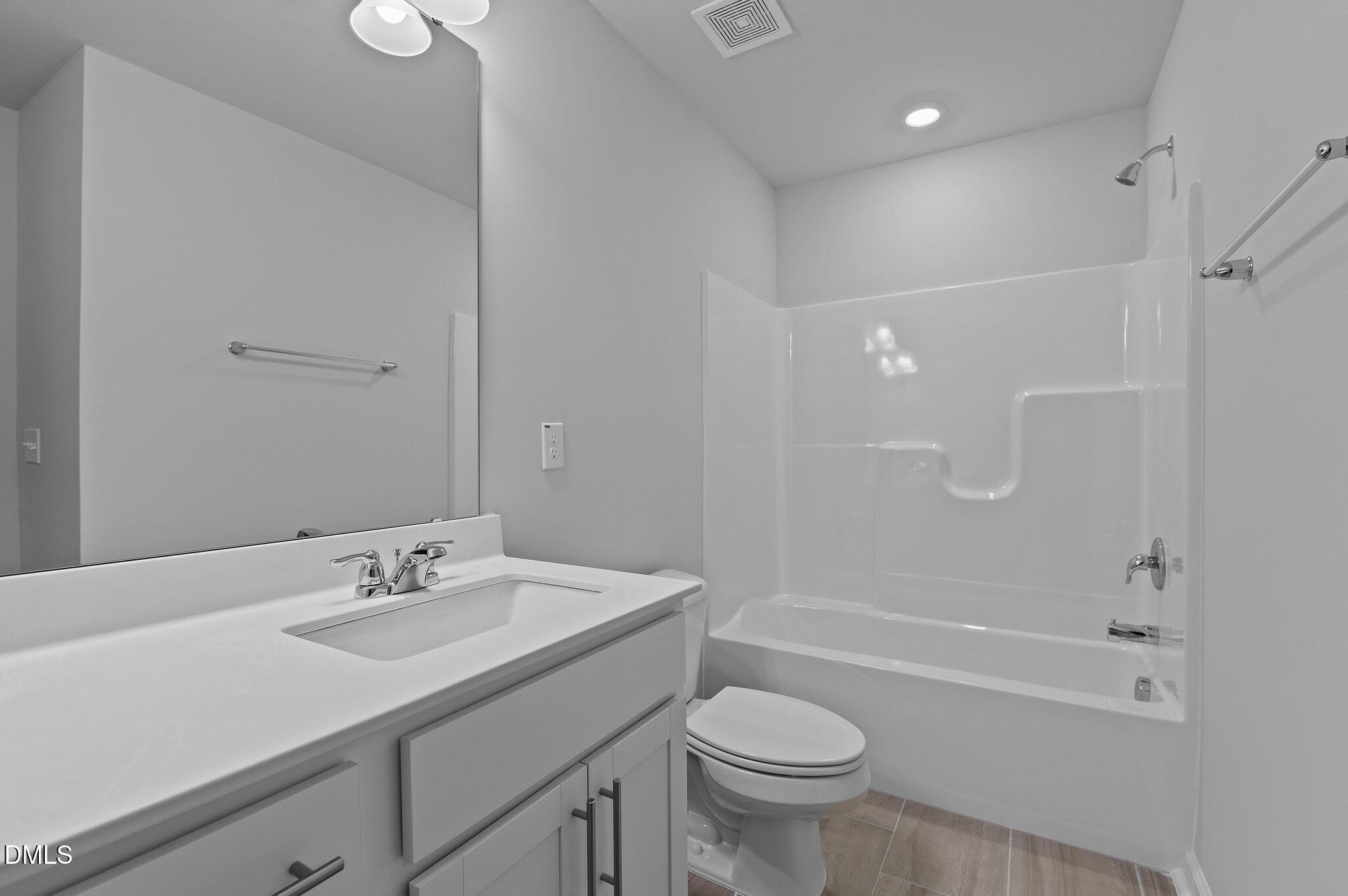 2202 Kasota Lane Raleigh, NC 27610 - Photo 45 of 79 a bathroom with a sink a toilet and shower