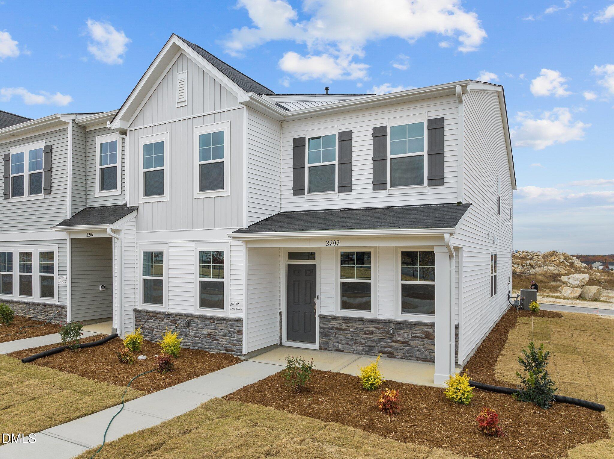 2202 Kasota Lane Raleigh, NC 27610 - Photo 7 of 79 a view of a white house with large windows next to a road