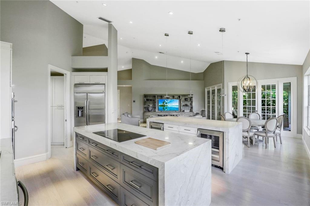 a kitchen with stainless steel appliances granite countertop a sink and a refrigerator