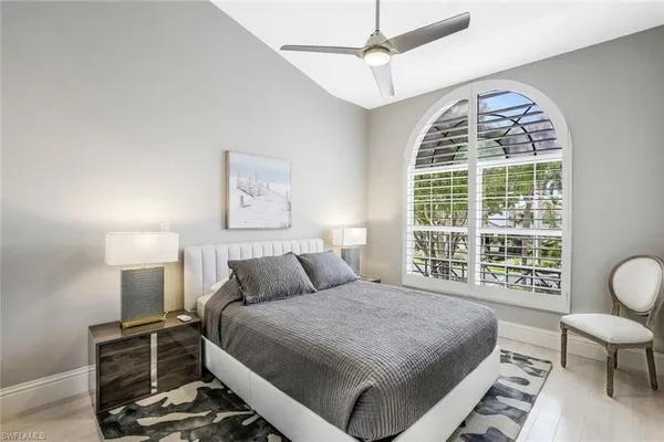 a bedroom with a large bed and a window