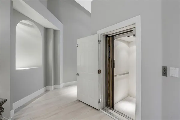 a view of a bathroom with a glass door and mirror