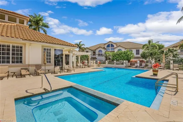 a view of a house with swimming pool and sitting area