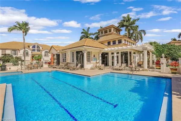 a front view of a house with swimming pool having outdoor seating